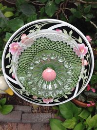 Another black, pink and green flower with vintage green crystal bowl and vintage candleholder as center.  SOLD at Galveston Island Market MiMi's Plate Flowers