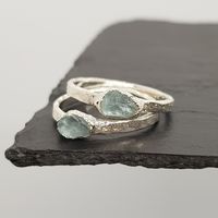 Raw Aquamarine Ring A stunning piece of raw aquamarine, a soft pastel blue stone, set in uniquely textured silver.Any rings noted as 'in stock' in the drop down menu will be shipped in a few days.Rings not in stock will require 1 - 2 weeks to be made (silver), and 2 - 3 weeks for gold plated silver.PLEASE NOTE: rings that are made to order are non-refundable. If you would like a size smaller or bigger than the sizes listed, please contact us here- stone: Aquamarine- stone size: approx. 5-8mm- me