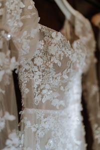 Close up detail shot of the beading and intricate lace details of the bride's Liz Martinez wedding dress. Georgina Harrison Photography.