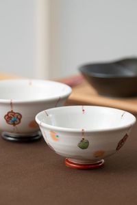 This small rice bowl is decorated with a gorgeous and lovely "Mizuhiki" motif. The colorful knotted balls give the bowl a nostalgic and graceful feeling. With a diameter of 11.5cm(4.5in), it is a perfect bowl for serving a small portion of rice. Highly recommended for your everyday simple table settings. Visit MUSUBI KILN to see other authentic Japanese tableware. | #Japanesetableware #japanesedinnerware #Japanesefood #Japanesecuisine