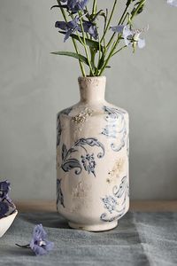 Weathered details add vintage appeal to this tall terracotta vase, wrapped in an intricate blue-and-white pattern. | Scrollwork Ceramic Vase, Tall at Terrain