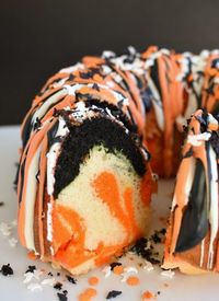 Easy Halloween Bundt Cake has orange, black, and white layers of cake with festive frosting! It's starts with a cake mix and a can of frosting! www.littledairyontheprairie.com #halloween #cake #halloweencake #orangeblackcake #easyhalloweencake #bundtcake #halloweenbundtcake #easyrecipe #holidays #baking #cakemix #halloweencakemix #halloweendesserts #dessert #tiedyedcake #halloweentiedyecake #blackfrosting #blackicing