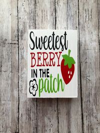 "Wooden strawberry sign with the words \"sweetest berry in the patch\" and a strawberry and flower to decorate any tiered tray, countertop, or shelf. The wood is reclaimed, painted, and varnished. Text and graphics are vinyl. Due to items being handmade, each one is unique in it's own way. Minor differences and imperfections are possible. My items are made from reclaimed wood. There are beautiful knots, cracks, nicks, and holes, that are untouched to preserve each piece of wood's natural charact