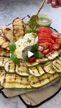 Vesela Asenova| Recipe Creator on Instagram: "Grilled Zucchini and Burrata  Board- it’s perfect for sharing or make it your own meal! 
Ingredients: 
3 small zucchini
1 heirloom tomato 
1/2 cup cherry tomatoes 
1/2 of a baguette 
1 garlic clove for rubbing the crostini 
2 Burrata cheese balls 
1/4 cup olive oil 
1 tsp salt 
Black pepper to taste 
2 tbs pesto- see my homemade pesto recipe on my Feed
Basil leaves 

Method: 
1. Wash and slice zucchini and season with olive oil, salt and pepper; mix and throw on the grill and cook both sides over medium heat; 
2. Slice baguette, season with olive oil, salt and pepper and grill on both sides; once grilled rub with a garlic clove; 
3. Assemble the board with crostini, grilled zucchini, sliced tomatoes, Burrata, pesto, a drizzle of olive oil, salt