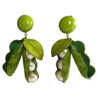 Light and easy to wear, this handmade artisanal pair of earrings was made in Paris by Cilea. The earrings feature two large whimsical peas in a pod of enameline (enamel and resin composite) with faux pearl center details. A unique, well-crafted statement pair of earrings with Parisian flair - signed Cilea Paris on the back.