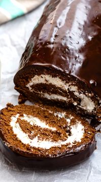 Swiss Chocolate Cake Roll is the perfect fancy dessert recipe. Cake Rolls are easy to make if you follow these directions! This chocolate roll cake has a whipped cream filling and a chocolate ganache topping. It's a rich homemade Swiss roll cake everyone will love!