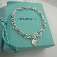 Brand New Authentic Tiffany & Co. Bangle Bracelet Including Tiffany’s Iconic Delicate Mini Heart Tag Charm. Solid 925 Sterling Silver And An Adult’s Size Medium Length Measuring 7 ~ 1/2” Long. Comes With The Tiffany & Co. The Original Box And Ribbon Are Included With Purchase. It Is In Perfect New Condition, Any Marks On The Photos Are Only Camera Glare . Note-->The Last Photo Shows The Multi Heart Bracelet, To Show What It Looked Like Before I Removed The All But One Heart. The Bracelet That Is