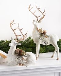 Decorate with a pair of wintry deer for a dash of woodland charm. Glittered antlers and foliage complement your refined holiday theme. | 17" White/Gold Winter Frost Tabletop Deer, Set of 2, Width 6 in by Balsam Hill