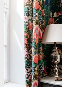 Pink florals and circular chains of blooms depicting peace symbols dazzle across the black background on the SUSIE Q linen, referencing the vivacity of the festival vibe itself. Bringing a whimsical, yet elegant feel to the print, the alluring pinks, yellows, and greens inject joy into any interior. #Woodstock #LifestyleCollection #mindthegap #premiumlinen #luxuryhomedecor