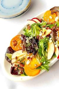 Golden Beet Salad features roasted golden beets, crisp apples, blue cheese, and pecans and is topped with a warm maple dijon dressing. This salad is perfect as a main meal, side salad, brunch, baby showers, Mother's Day and so many more occasions. Did I mention it is also vegan, dairy-free, and gluten-free (I used vegan blue cheese!)? | golden beet salad recipes | vegan golden beet salad recipe | roasted golden beet salad recipe