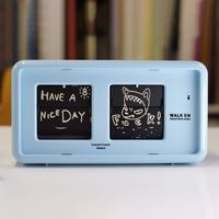 This cheeky 12-hour Walk On Flip Clock, a design by Yoshitomo Nara, features 84 original illustrations on the clock's 24-hour (12 a.m. and 12 p.m.) and 60-minute flaps one for every hour and minute, including a playful illustration of the f-bomb at zero minutes. An amusing design for your desktop or bedside table, the Yoshitomo Nara Walk On Flip Clock is made of plastic and measures 4.15h x 7.65w x 2.95"d. Yoshitomo Nara's work is represented in MoMA's collection. Requires one C battery (included). Not recommended for children.