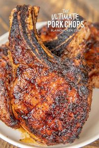 The Ultimate Pork Chops - so tender and juicy. You can cut them with a butter knife!!! Pork chops brined overnight in water, sugar and salt. Rub in a mixture of paprika, garlic powder, onion powder, cumin, dry mustard, pepper and chili powder. Seriously THE BEST!!! Everyone RAVES about these delicious grilled pork chops! #grill #grilling #pork #porkchops