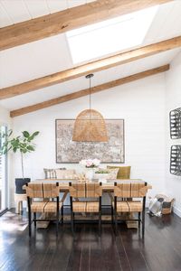 The architectural details of this open concept Dining Room give it a lot of character & sense to the overall vision. The slanted ceiling with shiplap and decorative beams creates a great contrast with the white walls and adds a Rustic twist we love.