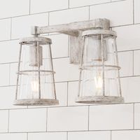 Combining blown glass, rope accents and rustic charm, this collection complements a myriad of styles from modern farmhouse and urban loft to classic colonial and coastal cottage. This bathroom wall light is perfect for updating a beach house bathroom or bringing the essence of the coast to any bathroom vanity. Inspired by light houses and other nautical elements, these lighting fixtures manage to tie into themes that go beyond coastal. The hand-applied finishes may have subtle variation, making