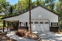 Pole Barn house built on concrete slab with 2-car garage and lean-to