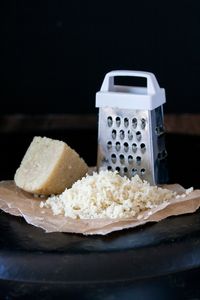 Grateable Vegan Parmesan like you've never seen. 5 ingredients and 5 minutes to freshly grated sharp, tangy Parmesan every night of the week! So easy to make and super versatile. #vegan #wholefoods #plantbased #vegancheese