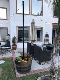 Learn how to build a sturdy backyard planter light post for your garden patio. Learn How to Make Planter Posts for String Lights. #planter #lightpost #sturdy #winebarrel