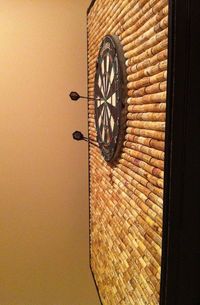 The worst part about playing darts is that when you miss—it can damage not only your ego, but also the wall behind the dartboard if it's not protected. Redditor mavantix found a solution to this problem in wine corks. Over a year, he collected over 1,000 corks from family and friends to make this DIY Cork Dartboard Cabinet—that's a lot of wine! After assembling a frame from scrap pieces of wood, he added trim and spray painted it black. The most time consuming part was gluing down all...