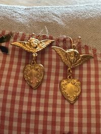 These angel and heart earring are gold tone charms hung on ear wires. We were so excited to find these charms and be able to offer them as darling earrings! Made in our Texas studio. They will arrive gift boxed.