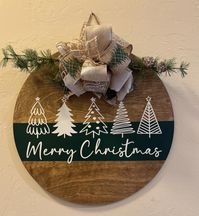 This is for a custom wooden door hanger that has been sanded and stained, painted and sealed for out doors.  Comes with greenery and bow attached and hanger on the back.   Felt piece attached to the back. 18 inch round. 1/4 inch thick.  All signs are painted so can have slight imperfections.   Great housewarming gift, christmas decor, perfect for front door.  More door hangers to come!! Can do custom last name ones too!