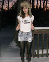 digital camera flash photography indie sleaze aesthetic revival 2024 faux fur trapper hat baby tee studded high waisted denim cutoff shorts tights outfit inspo tumblr 2014 it girl rockstar girlfriend blogging omighty winter snow pictures instagram