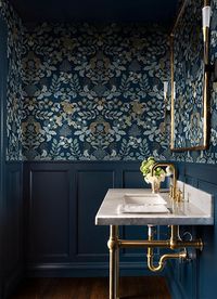 Add new life to your interiors with a rich dose of bohemian glamour. This contemporary damask wallpaper features leopards in repose framed by lush floral vines, the detailed inked in shades of light blue, white, and gold against rich navy.Drew and Jonathan Scott’s third wallpaper collection reaffirms their commitment to making a luxurious home accessible to all. The Scott Brothers' signature aesthetic is elevated by high end finishes, timeless botanicals, and geometric accents that are accompani