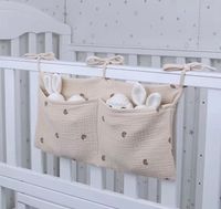 Super soft, muslin cot organiser. Perfect for storing all the bits you will need for the wakes in the night - nappies, wipes, tethers etc. The organiser has two pockets for storage. It is great for yr little one or as a gift for a new mum. When flat the organiser is 19cm x 38cm. This organiser can be purchased with our without personalisation - baby name (maximum 12 letters. The embroidery will be on the right-hand pocket. If you would like to add a name please provide the name and thread colour