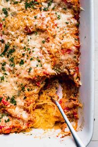 Spaghetti Squash Casserole made with tomatoes, Italian spices, creamy ricotta + parmesan is a delicious + hearty vegetarian meal.