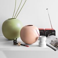 HOLLY is a spherical vase featuring natural shades emphasized by the glossy finish. Made from ceramic, it is perfect for holding flowers or decorating a corner of your home. It perfectly fits into every environment thanks to its elegant design.  Perfect also as gift idea.