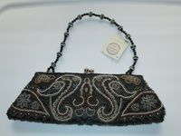 This listing is for a NEW Beautiful BEADED PURSEor EVENING BAG from Passports Fashion Express. It has a Black background with multi-colored beads in a Paisley and Flowers design.Beaded strap. It measures approx. 11" l x 4 1/2" h with a 7" strap drop. Tag reads "Sparkle Plenty". FREE SHIPPING!   Thanks for looking and please check out my other listings.                       &nb