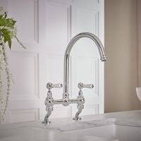 Add a touch of elegance to your kitchen with the beautifully designed Milano Elizabeth chrome and white cranked bridge kitchen mixer tap.A great choice for further elevating the look of your traditional style kitchen, this mixer tap features a timeless design and a hard-wearing chrome finish with white ceramic lever handles. Made from brass for strength and durability, the Elizabeth kitchen tap has lever handles, which provide effortless control, and a swivel spout for added convenience. It also incorporates ceramic disc technology, helping to prevent leaks and drips. Elizabeth Kitchen Sink Mixer Tap Features:  Dimensions: W 360mm x D 259mm x H 377mm Classic and elegant design - perfect for traditional kitchens Durable solid brass construction with chrome and white finish Ceramic lever han