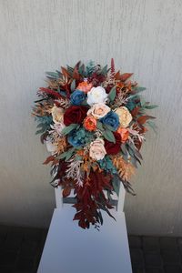 Embrace the rustic charm of autumn with rust fall bridal bouquet, a cascading masterpiece in serene light blue, ivory hues, rich burgundy tones and crafted from lifelike faux and silk flowers, is the epitome of timeless elegance. Perfect for your fall wedding, it adds a touch of nature-inspired romance to your special day. ○ Color: blue, dusty green, red, orange, burgundy ○ Personalization: I can make changes to your wishes ○ Processing time: 1 - 2 weeks ○ Shipping time: 7 - 14 business days NOTE  ○ I ship with REGISTERED mail and you will get a tracking number.  ○ All items will be carefully packed in special package materials.  ○ The actual color may differ slightly from the one you see on your monitor screen, as it depends on the specific monitor settings.  ○ In case some materials are