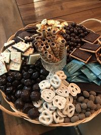 Mini Reese’s Cups, chocolate/coconut almonds, raspberries chocolate wafers, dark chocolate fruit and nit clusters, wrapped caramel bites, white chocolate covered pretzels, peppermint bark, cinnamon chocolate almonds, chocolate covered cherries, chocolate biscuits, and chocolate filled cigar cookies.