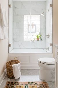 Glass shower door and glass block windows, marble herringbone floors and persian rug make for bright and modern master bath. Lakeview Chicago Master Bath — Sarah Montgomery Design