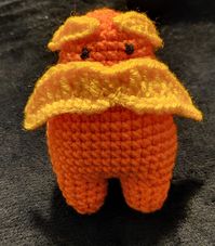 Just a cute and tiny Lorax plushie that is soft and cuddly. He speaks for the trees! c: