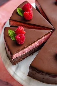 This layered raspberry mousse cake has a chewy chocolate brownie cake layer, light and fresh raspberry mousse, and gets covered in a glossy dark chocolate ganache. It's the perfect cake for Valentine's Day or a special gathering and is sure to please a crowd!