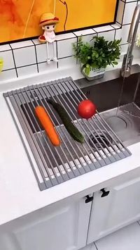 This Roll-Up Drainer Rack is a space-saving kitchen must-have made from silicone-coated steel which also doubles as washing and defrosting station for ingredients.