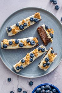 Blueberry Pie Protein Bars are delicious and filling! These pretty purple treats are quick to make for easy breakfasts on the go and after-school snacks.