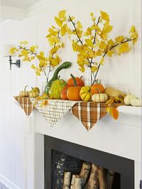 branches in vases and napkins on the mantel - splash of color that looks somewhat like bunting