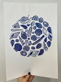 An original linocut art print of different shells in a circle, titled 'Shell Circle'. This design has been hand drawn, hand carved and hand printed by me, the artist. Quality Cranfield ink has been used to print the image onto acid free, 140 gsm art paper. Paper size: 29.7cm x 42cm (approximately) As each print is hand printed there could be variations from print to print, but this just adds to its uniqueness. International postage is now available, however please be aware that your country of o