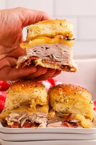 Boasting a delicious mixture of deli turkey, bacon, onion, cheese, and more, these easy turkey sliders certainly won't leave you or anyone else at the dinner table feeling hungry. They make a fun change from regular beef patty sliders and offer sweet and savory flavors in every mouthful. You can either make the recipe as it is or tweak the ingredients to personalize them. With bacon, maple syrup and cheese, these turkey sliders on Hawaiian rolls are ready in 30 minutes and a perfect party food!