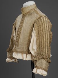 Doublet | British, 1650-1665 | Silver-gilt silk tissue, silver-gilt bobbin lace, silk taffeta, linen | Doublets formed part of the fashionable ensemble of clothing worn by men in Europe until the late 1660's. From 1650 to 1665, doublets shortened so that there was a gap between doublet and breeches through which the shirt could be seen. The centre back and front sleeves were left unstitched for further exposure of the shirt, which in the 17th century was considered underwear | VA Museum, London