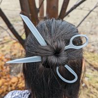 ✂️ Turn heads with a pair of scissors in your hair! ✂️ These scissor shaped hair pins may look sharp but they are safe and blunt! Wear both to give the illusion of a pair of scissors in your hair, or each pin can be worn individually. Includes 2x Scissor Shaped Hair Pins. Packaged in a jewelry box and very convenient for gifting!  The unique fabric scissor design and different colour options make this a perfect gift for any seamstress, fashion designer or maker.  ~7" Length, ~0.2" Thick 3D Print