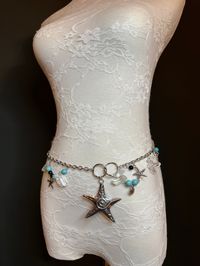 Fashionable and Beautiful Textured Star Fish Metal Belt with Chain. Perfect with a range of outfits.  Handcrafted with beads and chain. Perfect for Beach, Resortwear, Gifts, Dresses.  Just choose your waist size in inches, all belts come with an extra 12 inch chain.   Tap into the hottest new trend with chain belts! This chic piece of bodywear can be draped over your clothing to enhance your outfit or worn with bare midriff looks. Pair it with a simple black ensemble for an elegant finish. Perfe