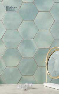 Spanish porcelain encaustic hexagon tiles, Sasha Hex Bettina Blue Green, evoke azure waves crashing on white sandy beaches. 6" matte, worn-in look elevates walls, floors. Ombre, seven hues.