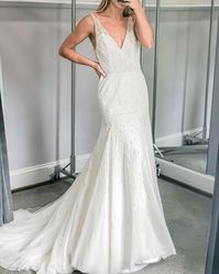 Blythe by Enaura Bridal | Fit and flare with v-neckline, Ivory leaf like beading cascading throughout | #fitandflare #fitandflareweddingdress #weddingdress #weddingdressideas #weddingdressinspiration #bridalgown #weddingogwn #beadedweddingdress