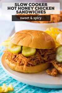 Slow Cooker Hot Honey Chicken Sandwiches are an easy, spicy dinner idea made right in the crock pot. Pulled chicken cooked in a hot honey sauce and then piled onto your favorite bun. The perfect slow cooker meal for any time of year! | www.persnicketyplates.com