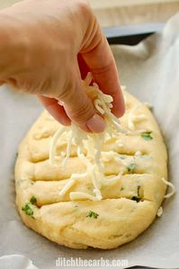 The MOST POPULAR recipe for cheesy keto garlic bread - using mozzarella dough. #lowcarbbread #ketobread #glutenfreegarlicbread #healthygarlicbread