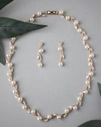 A simple design of marquise CZ leaves alternating with off-white pearls, a lovely style for any special occasion. The necklace is 16.5 inches long, the earrings are 1.5 inches long with post-pierced backs. Available in rhodium or gold plate, AAA grade CZ, lead, nickel, and cadmium free. #costumejewelry #jewellry #fashionjewelry #bridaljewelry