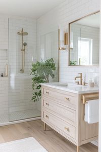 Explore this serene bathroom retreat with trendy brass fixtures and sleek subway tiles. Perfect for those seeking stylish yet functional modern bathroom ideas. #HomeDesign #BathroomDecor #ModernLiving